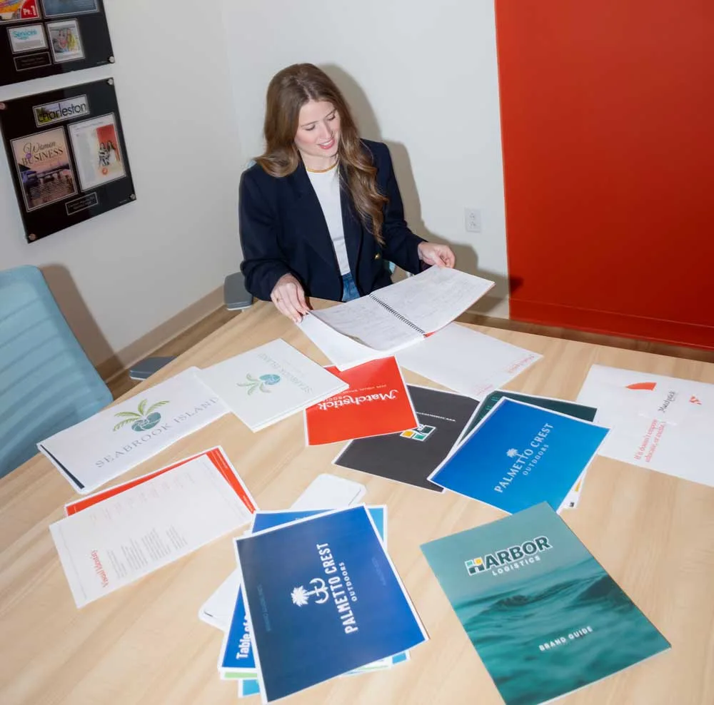 Marketing and branding materials laid out on a conference table at Matchstick Social