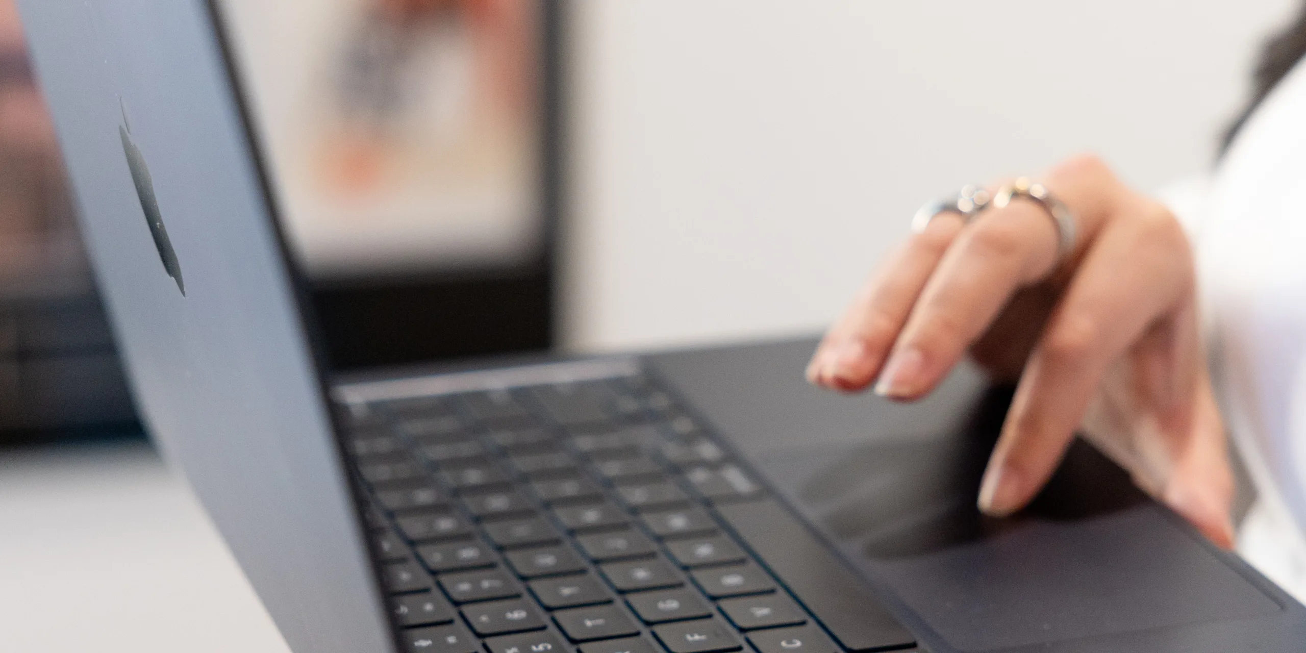 Close-up of a person using a laptop trackpad while working on a MacBook, representing the role of a social media marketing funnel in a modern digital marketing strategy.
