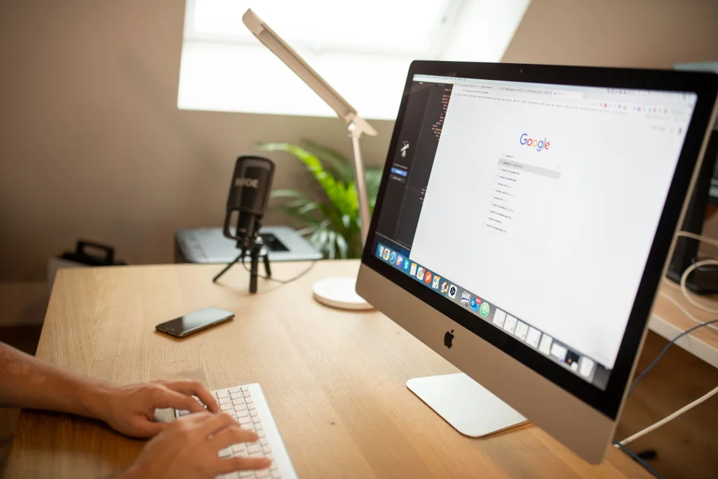 Business owner comparing reputation management companies on a laptop before hiring.